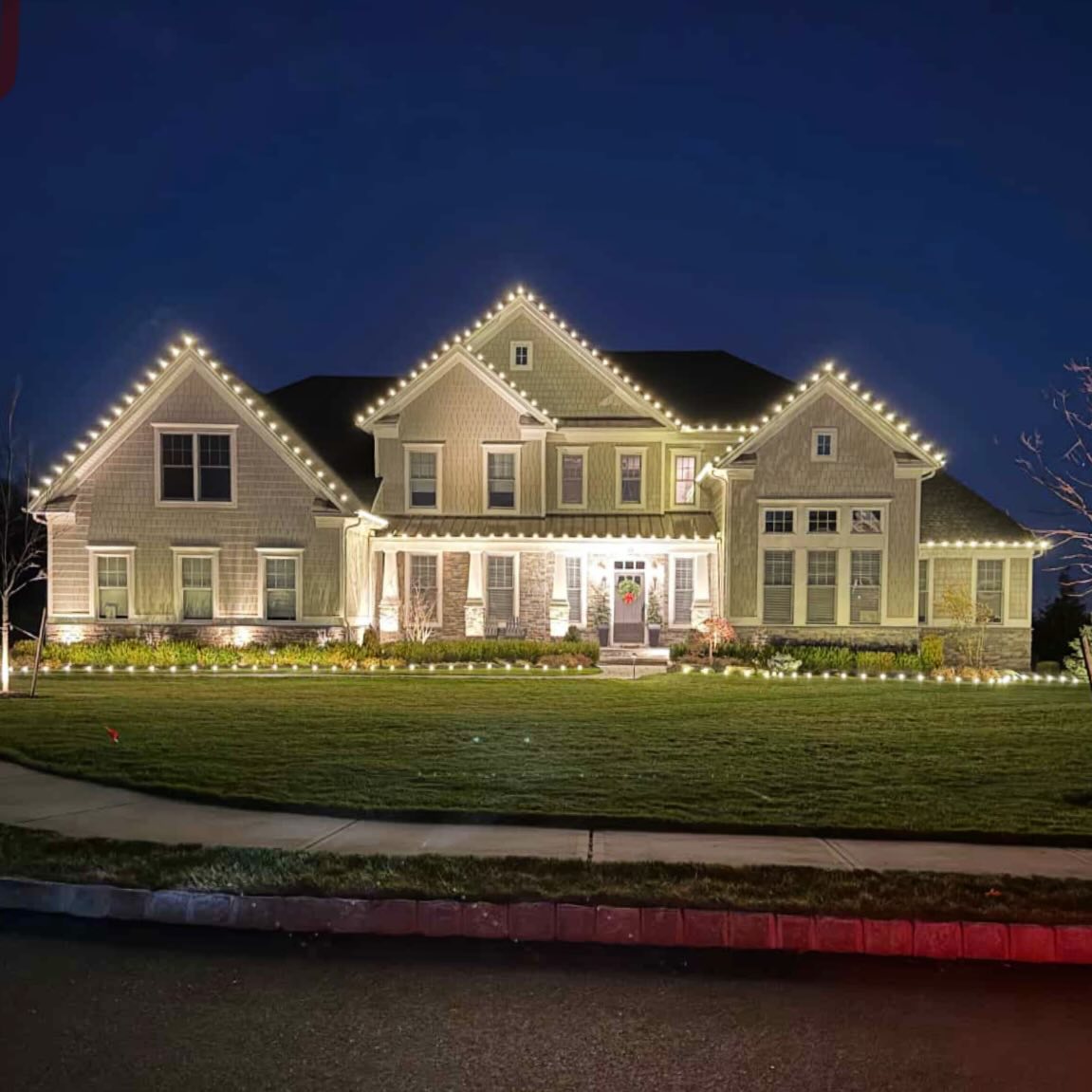 Professional holiday lighting installation New Jersey — full estate warm white C9 roofline display Somerset County